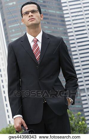 Close-up of a businessman standing with his hand in his pocket View Large Photo Image Stock Image - Close-up of a businessman standing with his hand in his pocket. Fotosearch