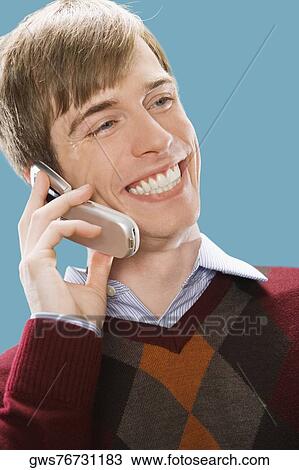 Close-up of a businessman talking on a mobile phone and smiling View Large Photo Image Stock Image - Close-up of a businessman talking on a mobile phone and smiling. Fotosearch