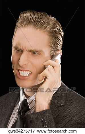Close-up of a businessman talking on a mobile phone View Large Photo Image Stock Photo - Close-up of a businessman talking on a mobile phone. Fotosearch