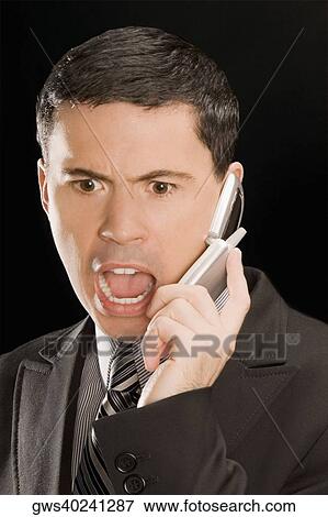 Stock Photo - Close-up of a businessman talking on a mobile phone. Fotosearch