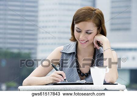Close-up of a businesswoman at a sidewalk cafe View Large Photo Image Stock Image - Close-up of a businesswoman at a sidewalk cafe. Fotosearch