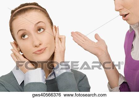 Close-up of a businesswoman covering her ears with fingers View Large Photo Image Stock Photograph - Close-up of a businesswoman covering her ears with fingers. Fotosearch