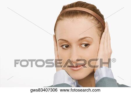 Close-up of a businesswoman covering her ears with her hands View Large Photo Image Stock Photograph - Close-up of a businesswoman covering her ears with her hands. Fotosearch
