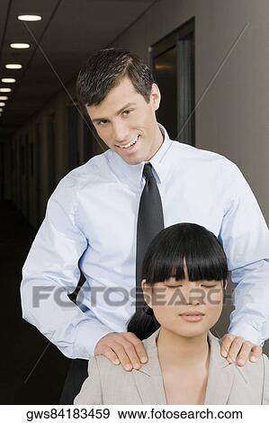 Close-up of a businesswoman rubbing a businesswoman's shoulders View Large Photo Image Stock Photo - Close-up of a businesswoman rubbing a businesswoman's shoulders. Fotosearch