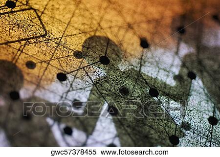 Stock Photography - Close-up of a circuit board with paper chain dolls shadow on it. Fotosearch