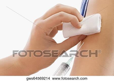 Close-up of a doctor giving injection to a patient View Large Photo Image Picture - Close-up of a doctor giving injection to a patient. Fotosearch