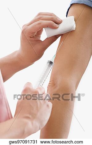Close-up of a doctor giving injection to a patient View Large Photo Image Stock Image - Close-up of a doctor giving injection to a patient. Fotosearch