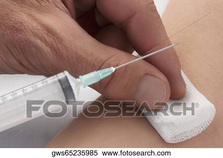 Close-up of a doctor giving injection to a patient View Large Photo Image Stock Photography - Close-up of a doctor giving injection to a patient. Fotosearch