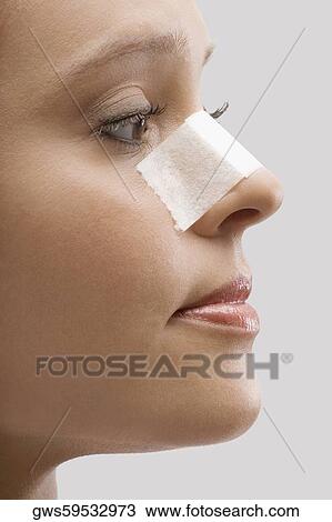 Close-up of a female patient with an adhesive bandage on her nose View Large Photo Image Stock Image - Close-up of a female patient with an adhesive bandage on her nose. Fotosearch