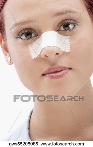 Close-up of a female patient with an adhesive bandage on her nose View Large Photo Image Stock Photography - Close-up of a female patient with an adhesive bandage on her nose. Fotosearch