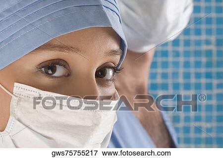 Close-up of a female surgeon wearing a surgical mask View Large Photo Image Stock Photo - Close-up of a female surgeon wearing a surgical mask. Fotosearch