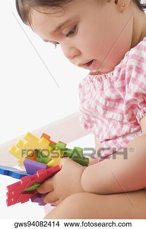 Close-up of a girl playing with toys View Large Photo Image Picture - Close-up of a girl playing with toys. Fotosearch