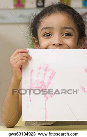 Close-up of a girl showing a drawing View Large Photo Image Stock Image - Close-up of a girl showing a drawing. Fotosearch