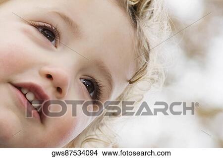Close-up of a girl smiling View Large Photo Image Picture - Close-up of a girl smiling. Fotosearch