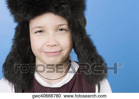 Stock Image - Close-up of a girl wearing a fur hat. Fotosearch