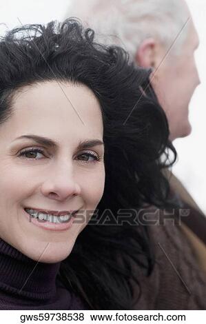 Stock Photo - Close-up of a mature woman with a senior man behind her. Fotosearch
