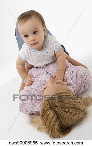 Close-up of a mid adult woman playing with her baby boy View Large Photo Image Stock Photography - Close-up of a mid adult woman playing with her baby boy. Fotosearch