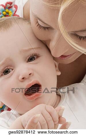 Close-up of a mid adult woman with her son View Large Photo Image Stock Image - Close-up of a mid adult woman with her son. Fotosearch