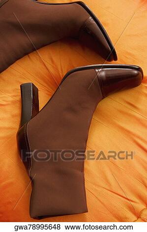Stock Photo - Close-up of a pair of boots on a cushion. Fotosearch