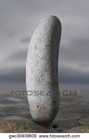 Close-up of a pebble on a rock surface View Large Photo Image Stock Photo - Close-up of a pebble on a rock surface. Fotosearch