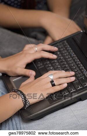 Close-up of a person's hands using a laptop View Large Photo Image Stock Image - Close-up of a person's hands using a laptop. Fotosearch