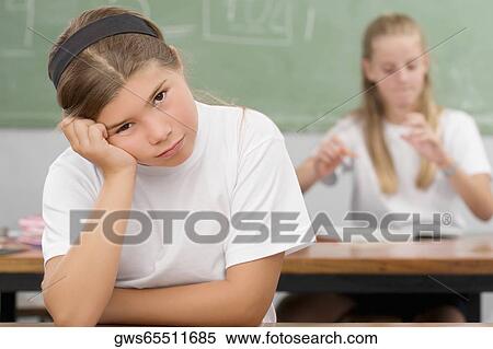 Close-up of a schoolgirl thinking in a classroom View Large Photo Image Stock Photography - Close-up of a schoolgirl thinking in a classroom. Fotosearch