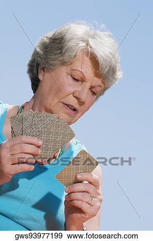 Close-up of a senior woman playing cards View Large Photo Image Stock Photo - Close-up of a senior woman playing cards. Fotosearch
