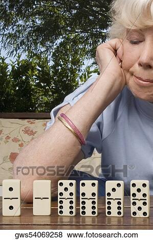 Stock Photo - Close-up of a senior woman playing dice. Fotosearch
