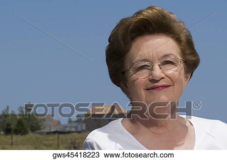 Close-up of a senior woman smiling View Large Photo Image Stock Image - Close-up of a senior woman smiling. Fotosearch