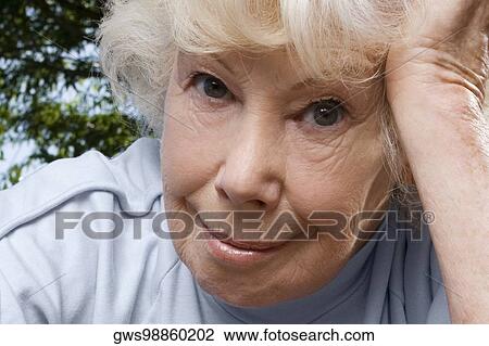 Close-up of a senior woman smiling View Large Photo Image Stock Image - Close-up of a senior woman smiling. Fotosearch
