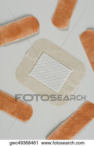 Close-up of a square shaped adhesive bandage with adhesive bandages View Large Photo Image Stock Image - Close-up of a square shaped adhesive bandage with adhesive bandages. Fotosearch