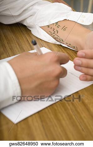 Stock Image - Close-up of a student copying in an examination. Fotosearch
