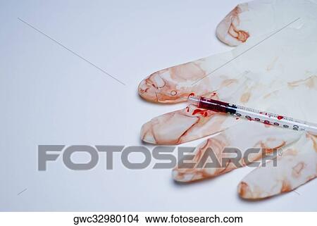 Close-up of a syringe on a blood soaked surgical glove View Large Photo Image Picture - Close-up of a syringe on a blood soaked surgical glove. Fotosearch