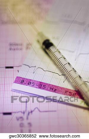 Close-up of a syringe on a medical report View Large Photo Image Stock Image - Close-up of a syringe on a medical report. Fotosearch