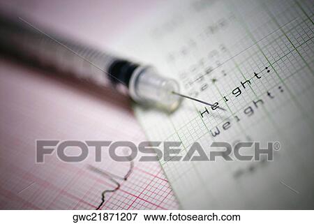 Close-up of a syringe on a medical report View Large Photo Image Stock Photo - Close-up of a syringe on a medical report. Fotosearch