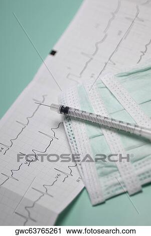 Close-up of a syringe on an electrocardiogram report View Large Photo Image Stock Image - Close-up of a syringe on an electrocardiogram report. Fotosearch