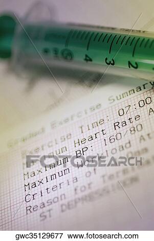 Close-up of a syringe on an electrocardiogram report View Large Photo Image Stock Photo - Close-up of a syringe on an electrocardiogram report. Fotosearch