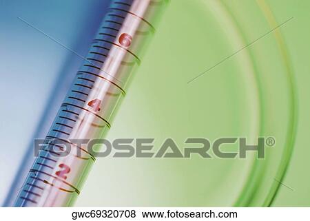Stock Photo - Close-up of a syringe with a petri dish. Fotosearch