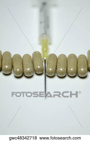 Close-up of a syringe with capsules View Large Photo Image Stock Photo - Close-up of a syringe with capsules. Fotosearch