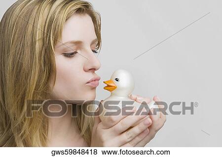 Close-up of a teenage girl kissing a rubber duck View Large Photo Image Stock Photo - Close-up of a teenage girl kissing a rubber duck. Fotosearch
