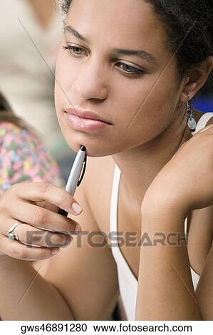 Stock Image - Close-up of a teenage girl thinking. Fotosearch