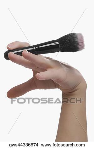 Close-up of a woman's hand holding a make-up brush View Large Photo Image Picture - Close-up of a woman's hand holding a make-up brush. Fotosearch