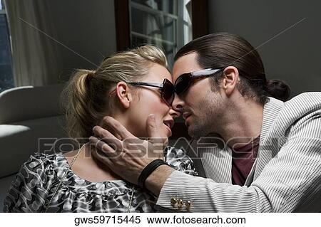 Stock Photography - Close-up of a young couple kissing each other. Fotosearch