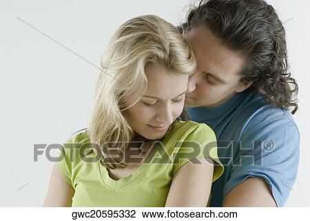 Close-up of a young couple romancing View Large Photo Image Stock Image - Close-up of a young couple romancing. Fotosearch
