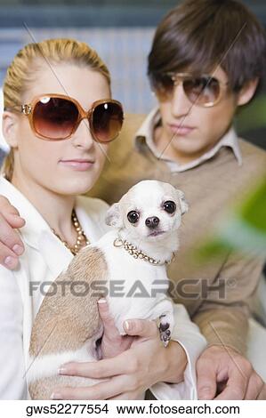 Picture - Close-up of a young couple with a puppy. Fotosearch