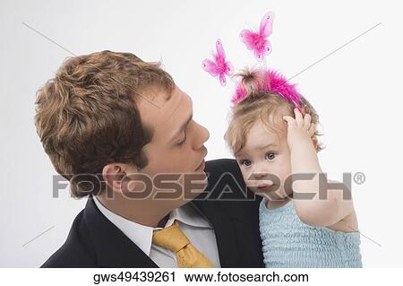 Stock Image - Close-up of a young man looking at his daughter. Fotosearch