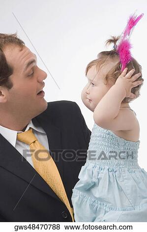 Close-up of a young man looking at his daughter View Large Photo Image Stock Photo - Close-up of a young man looking at his daughter. Fotosearch