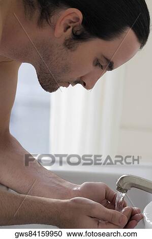 Close-up of a young man washing his face View Large Photo Image Stock Image - Close-up of a young man washing his face. Fotosearch