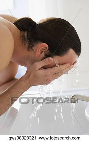 Close-up of a young man washing his face View Large Photo Image Stock Image - Close-up of a young man washing his face. Fotosearch