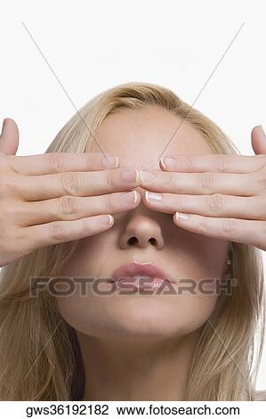 Close-up of a young woman covering her eyes with her hands View Large Photo Image Stock Image - Close-up of a young woman covering her eyes with her hands. Fotosearch